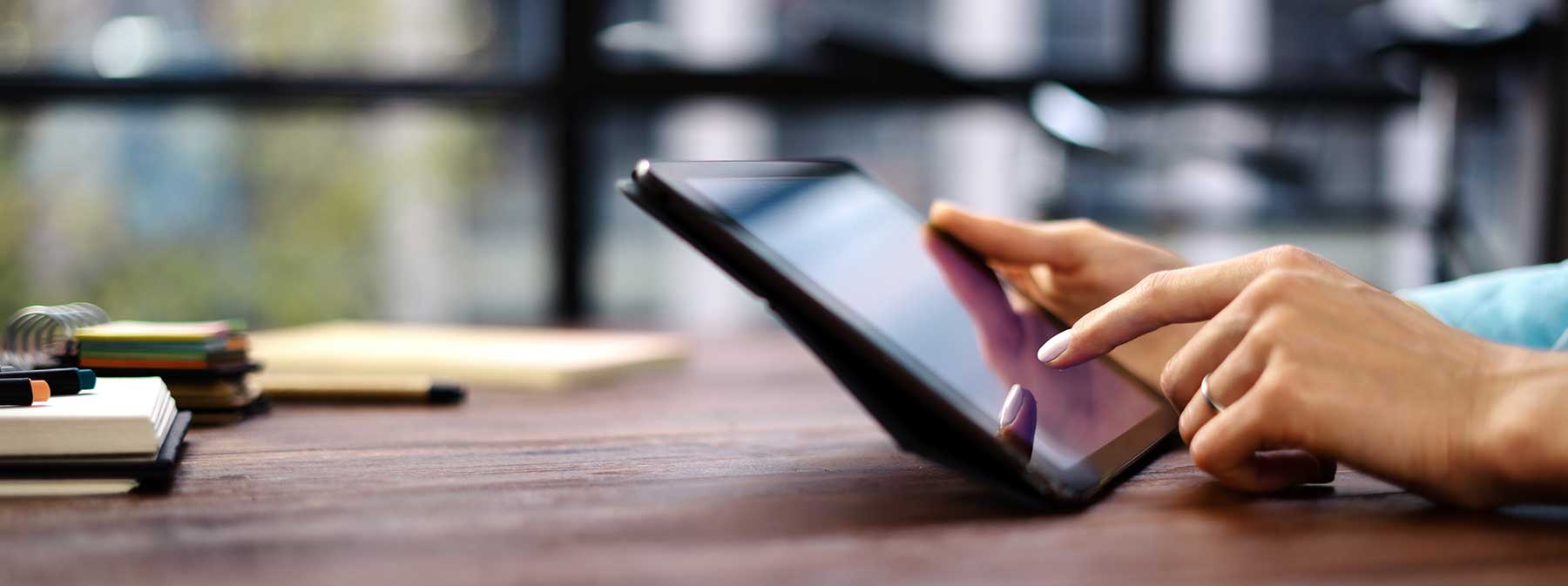 woman using tablet to access application