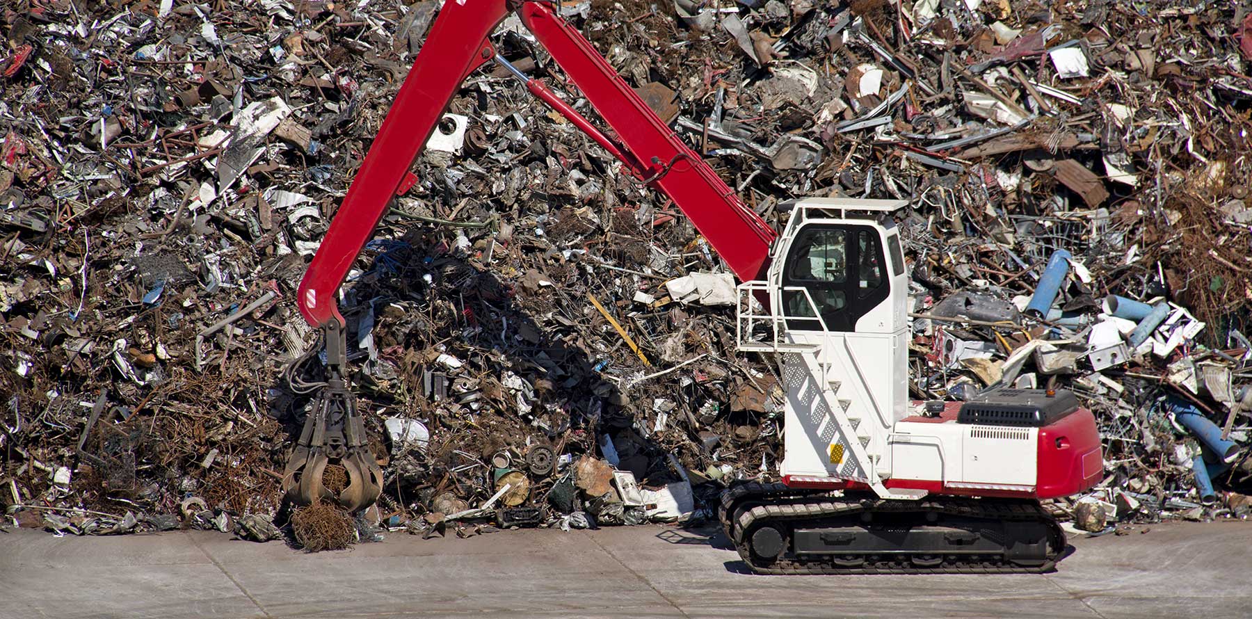 scrap metal pile and maching with arm